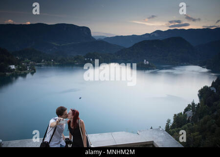 Young couple from Slovenia is kissing whilst taking selfie above Bled lake, Triglav, Slovenia Stock Photo