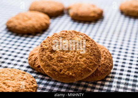 Anzac Biscuits on tablecloth. Traditional Cookies. Stock Photo