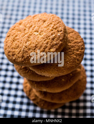 Anzac Biscuits on tablecloth. Traditional Cookies. Stock Photo