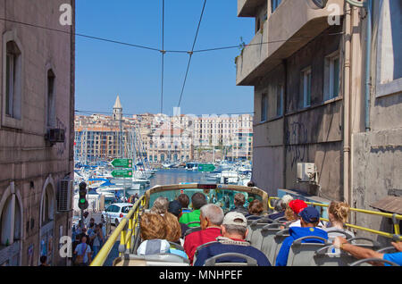 City tour, tourist in bus driving at narrow alley to the old harbour Vieux Port, Marseille, Bouches-du-Rhone, Provence-Alpes-Côte d’Azur, France Stock Photo