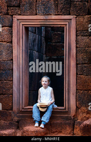 Little girl in ancient Banteay Srei temple in Siem Reap,  Cambodia Stock Photo