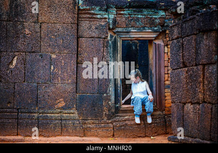Little girl in ancient Banteay Srei temple in Siem Reap,  Cambodia Stock Photo