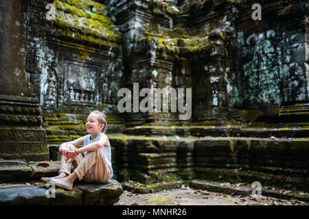 Little girl in ancient Angkor Wat temple in Siem Reap,  Cambodia Stock Photo