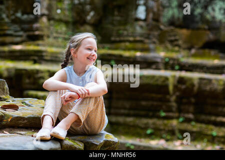 Little girl in ancient Angkor Wat temple in Siem Reap,  Cambodia Stock Photo