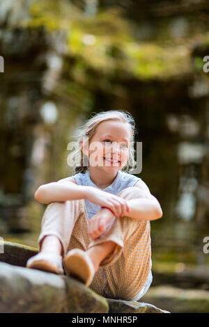 Little girl in ancient Angkor Wat temple in Siem Reap,  Cambodia Stock Photo