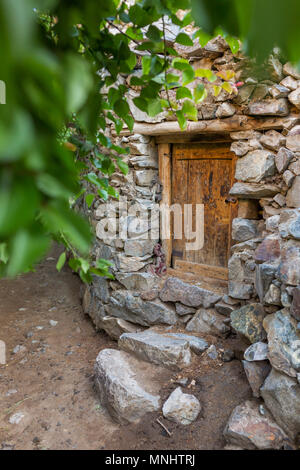 Old wooden door in stone house in Dah village, Ladakh region, India Stock Photo
