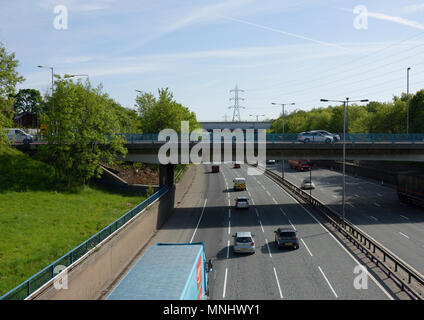 Traffic on M60 motorway four lane section at junction 17 passing under A56 road in whitefield greater manchester uk Stock Photo