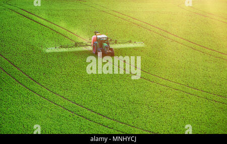 Farm machinery spraying insecticide Stock Photo