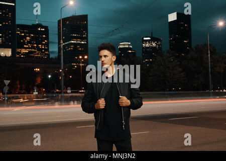 Boy posing outside building at night - PixaHive