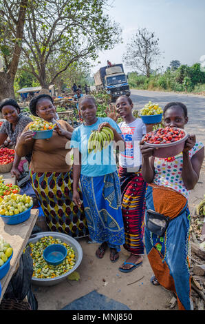 Unidentified African women presenting their vegetables at road market Stock Photo