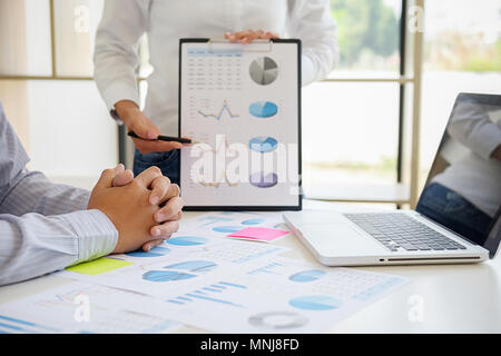 Business adviser analyzing financial figures denoting the progress Internal Revenue Service checking document. Audit concept Stock Photo