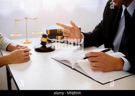 Justice and Law concept. Legal counsel presents to the client a signed contract with gavel and legal law or legal having team meeting at law firm Stock Photo