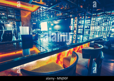 The part of the contemporary bar counter on the stylish inside decor background in the modern restaurant. Fully equipped bar with the latest technolog Stock Photo