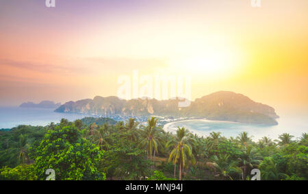 Spectacular landscape the limestone cliffs in the crystal clear ocean next to the exotic Phi Phi Islands, the Kingdom of Thailand. Amazing sunrise in  Stock Photo