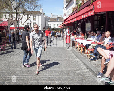 PARIS, FRANCE-MAY 6, 2016: Place du Tertre in Montmartre in the spring sunny day with many people on it Stock Photo