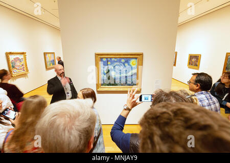 MoMA - Museum of Modern Art New York interior - people looking at ' The Starry Night ' oil painting by Vincent Van Gogh, MoMA, New York city USA Stock Photo