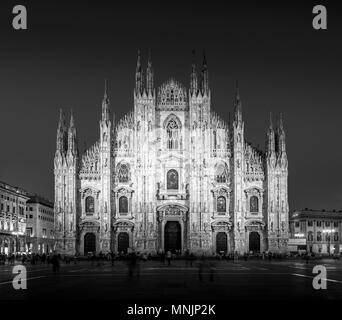 MILAN, ITALY - APRIL 28th, 2018: turists during blue hour taking pictures in Duomo Square , the main landmark of the city. Stock Photo