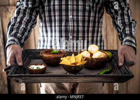 Man with snacks and dips. Tortilla mexican food Stock Photo