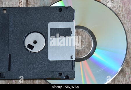 diskette and compact disc on wood board Stock Photo