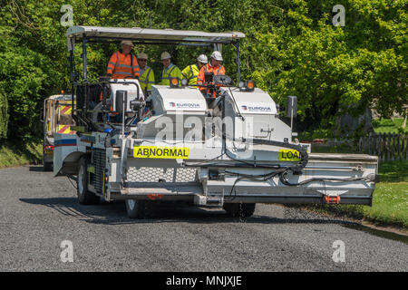 Road resurfacing team as work in an Essex village Stock Photo