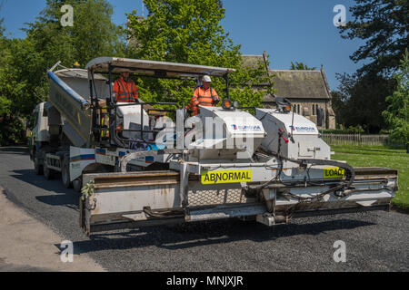 Road resurfacing team as work in an Essex village Stock Photo
