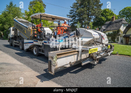 Road resurfacing team as work in an Essex village Stock Photo