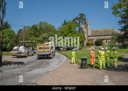 Road resurfacing team as work in an Essex village Stock Photo