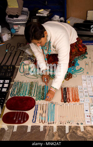 Women arranging turquoise necklaces display for sale in Santa Fe, New Mexico Stock Photo