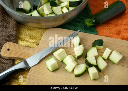 Healthy chopped zucchini on a cutting board with knife Stock Photo