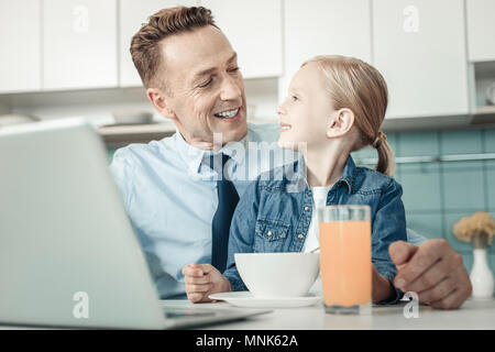 Happy family having friendly talk in the kitchen Stock Photo