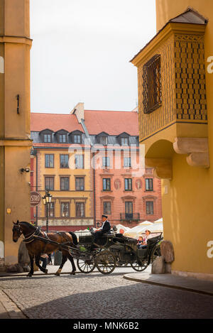 Warsaw Old Town, tourists take a summer carriage ride through the reconstructed Baroque Old Town (Stare Miasto) area in the center of Warsaw, Poland. Stock Photo