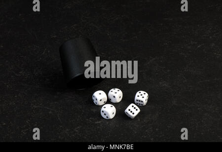Closeup of 5 dice used for gambling on a table Stock Photo