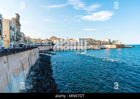 Siracusa, Italy - August 17, 2017: Promenade next to the sea with people around in the old town of the historic city of Siracusa in Sicily, Italy Stock Photo