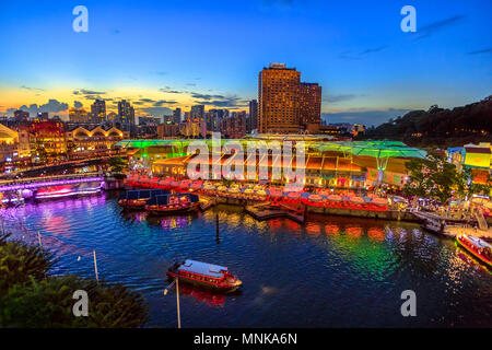 Scenic aerial view of Clarke Quay and Riverside area at blue hour in Singapore, Southeast Asia. Waterfront skyline reflected on Singapore River. Popular attraction for nightlife. Stock Photo