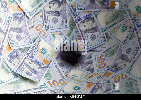 Hundred Dollar Bills Going Down the Drain. Stock Photo