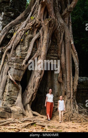 Family mother and child visiting ancient Ta Som temple in Angkor Archeological area in Cambodia Stock Photo