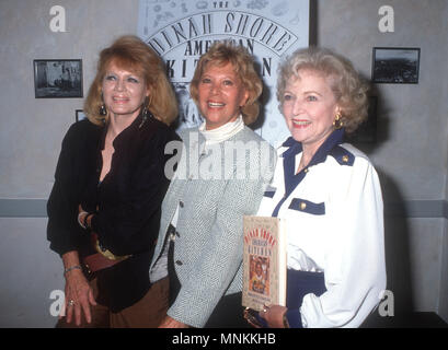 BEVERLY HILLS, CA - OCTOBER 29: (L-R) Actress Angie DIckinson, TV personality Dinah Shore and actress Betty White attend Dinah Shore Book Party for 'American Kitchen' at Orso Restaurant on October 29, 1990 in Beverly Hills, California. Photo by Barry King/Alamy Stock Photo Stock Photo