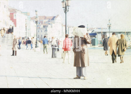 Tourist reading a map on San Marco's waterfront, Venice Stock Photo