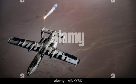 A U.S. Air Force A-10 Thunderbolt II pilot breaks right and releases flares over Afghanistan after completing aerial refueling operations with a KC-135 Stratotanker, assigned to the 340th Expeditionary Air Refueling Squadron Detatchment 1, in support of Operation Freedom's Sentinel, March 12, 2018. The A-10 is primarily deployed to provide close air support to U.S. and coalition forces operating as part of NATO’s Resolute Support mission. Stock Photo