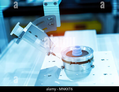 Robot holding glue syringe Injection Stock Photo