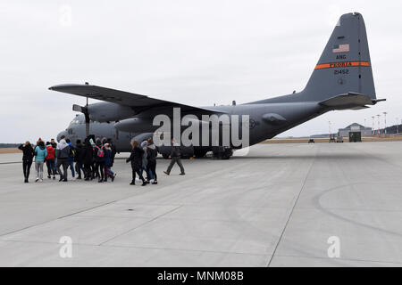 Students from Liceum Ogólnoksztłcące im. Adama Mickiewiczat, a nearby high school, walk to a C-130 Hercules aircraft at Powidz Air Base, Poland, March 16, 2018. The students toured the aircrew flight equipment section before visiting the aircraft. Approximately 70 Airmen and three C-130s from the 182nd Airlift Wing are participating in bilateral training with the Polish Air Force during Aviation Rotation 18-2 in support of Operation Atlantic Resolve. These events occur across the U.S. European Command area of responsibility and are designed to enhance partner interoperability, maintain joint r Stock Photo