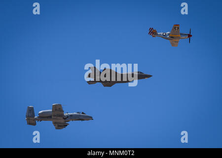 The Heritage Flight, comprising of the P-51 Mustang, F-35 Lightning II and A-10 Thunderbolt, performs a fly by during Luke Days at Luke Air Force Base, Ariz., March 17, 2018. Luke Days demonstrates the capabilities of modern military and civilian airpower through the display of more than 30 live air and ground demonstrations and static exhibits. Stock Photo