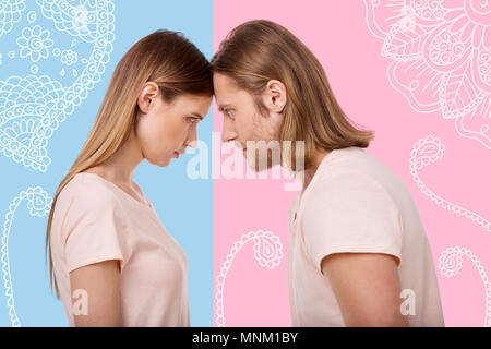 Angry young people touching their foreheads and looking stubborn Stock Photo