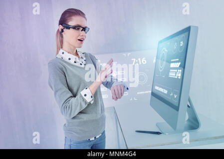 Emotional programmer feeling impressed while using new smart watch Stock Photo