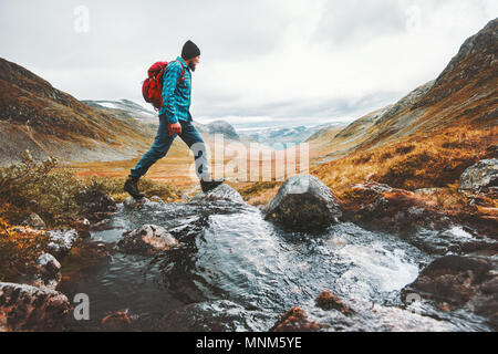 Man solo traveling backpacker hiking in scandinavian mountains active healthy lifestyle adventure journey vacations Stock Photo