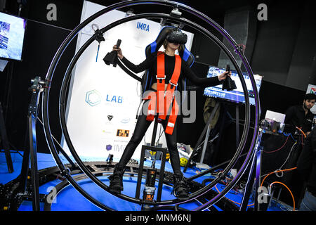 Milan, Italy - 17 May 2018: A woman tries VITRUVIAN VR, a gyroscope Virtual Reality simulator,  on display during the Technology Hub 2018. Stock Photo