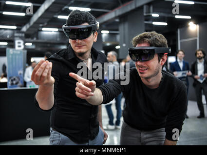 Milan, Italy - 17 May 2018: Two young men wearing VR Virtual Reality headsets gesticulate and interact together  during the Technology Hub 2018. Stock Photo