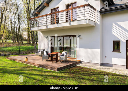 Shot of a modern white detached house with a terrace Stock Photo