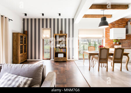 Shot of a cozy home interior with a dining table, a sofa and cupboards Stock Photo