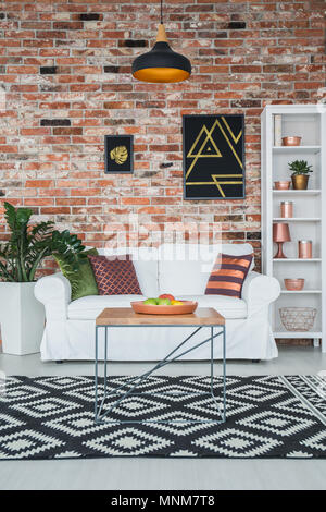 Living room in industrial style with brick wall and couch Stock Photo